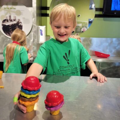 A child in a children's museum exploring food